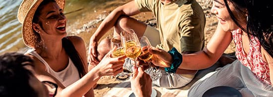 Menschen an Strand trinken Weißwein